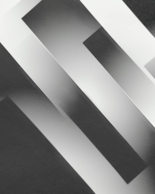 Minimalist abstract design featuring black and white geometric shapes in grayscale.